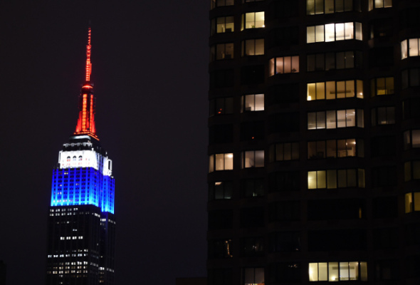 The Empire State building is lighted up in the colors of the French flag to pay tribute to those that lost their lives in the terrorist attacks at Charlie Hedbo on January 11, 2015 in New York. The building was dimmed for five minutes of silence in memory of those that were killed. AFP PHOTO /  TIMOTHY  A. CLARY        (Photo credit should read TIMOTHY A. CLARY/AFP/Getty Images)